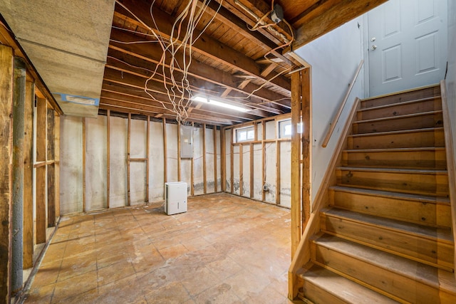 basement with stairway and electric panel