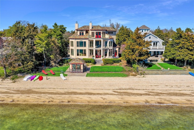 exterior space with a gazebo, a chimney, fence private yard, and a balcony