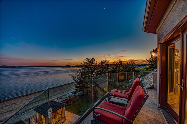 balcony at dusk with a water view
