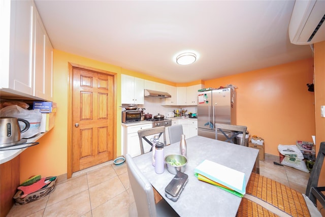 dining area featuring a wall unit AC and light tile patterned flooring