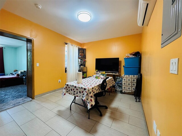 bedroom with a wall mounted air conditioner and light tile patterned floors