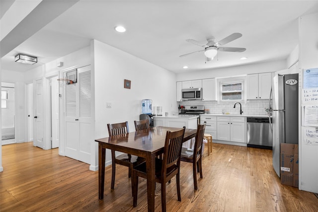 dining area with a ceiling fan, recessed lighting, and light wood-type flooring