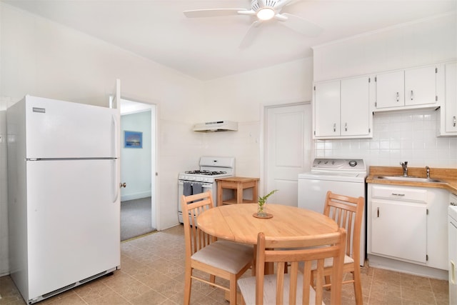 26 S Eckar St, Irvington, NY 10533 - kitchen with white appliances, under cabinet range hood, washer / dryer, ceiling fan, and white cabinetry