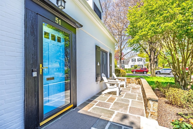 property entrance featuring brick siding