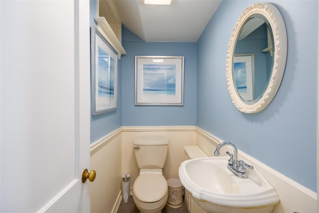 bathroom with toilet and a sink