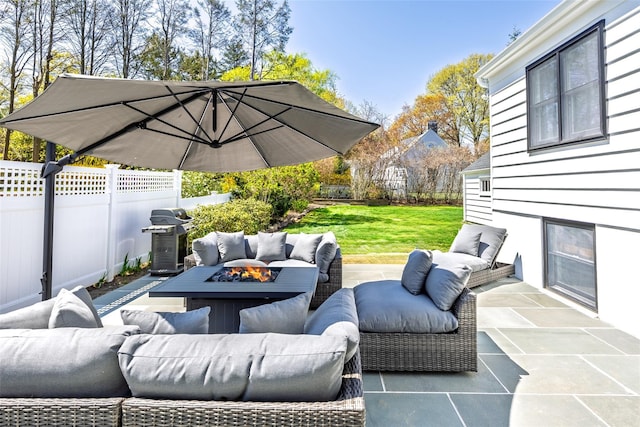 view of patio featuring fence, area for grilling, and an outdoor living space with a fire pit