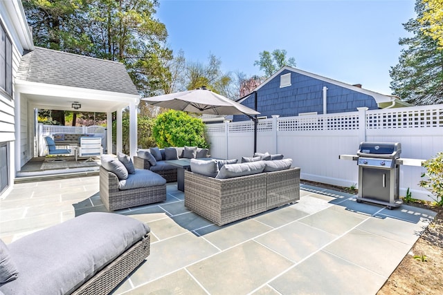 view of patio featuring fence, area for grilling, and an outdoor living space