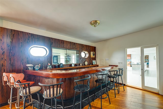 bar with wood-type flooring and bar area