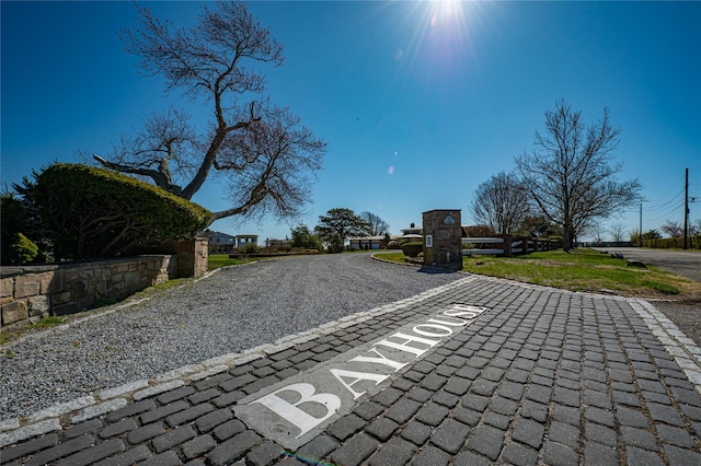 view of road with gravel driveway
