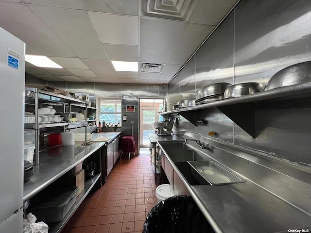 18-24 College Point Blvd, College Point, NY 11356 - kitchen featuring stainless steel countertops, a drop ceiling, dark tile patterned floors, and a sink