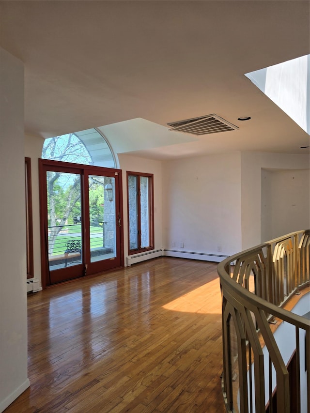 22 Lake Rd, Great Neck, NY 11020 - interior space featuring visible vents, baseboards, wood finished floors, and baseboard heating