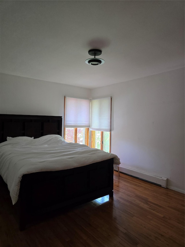 22 Lake Rd, Great Neck, NY 11020 - bedroom featuring baseboards, a baseboard heating unit, and wood finished floors