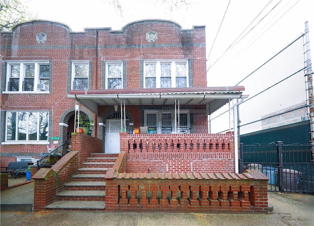 2250 E 23rd St, Brooklyn, NY 11229 - townhome / multi-family property featuring brick siding, fence, and a porch