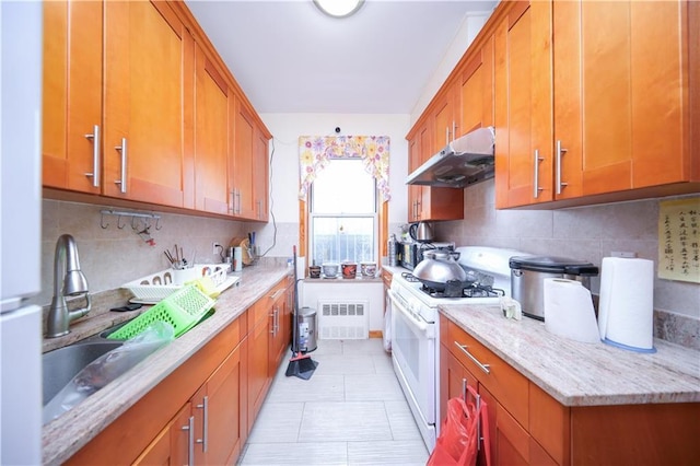 2250 E 23rd St, Brooklyn, NY 11229 - kitchen with a sink, brown cabinets, under cabinet range hood, decorative backsplash, and white range with gas stovetop