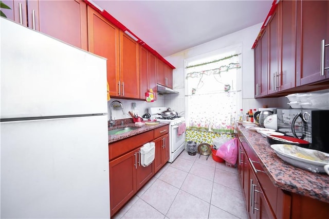 2250 E 23rd St, Brooklyn, NY 11229 - kitchen with white appliances, dark stone counters, light tile patterned floors, under cabinet range hood, and a sink