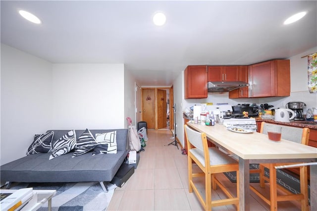 2250 E 23rd St, Brooklyn, NY 11229 - kitchen with range, recessed lighting, light tile patterned floors, and under cabinet range hood