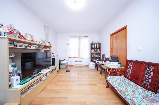 2250 E 23rd St, Brooklyn, NY 11229 - living area featuring radiator heating unit and wood finished floors