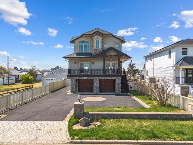 83 Central Ave, Amityville, NY 11701 - view of front of house featuring stairway, aphalt driveway, a garage, and stone siding