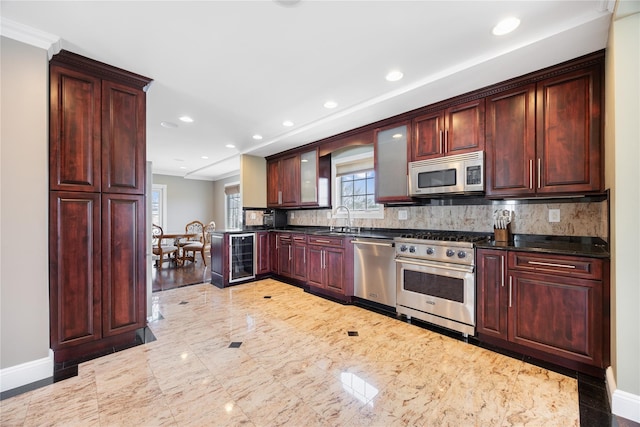 83 Central Ave, Amityville, NY 11701 - kitchen with a sink, stainless steel appliances, baseboards, recessed lighting, and wine cooler