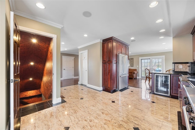 83 Central Ave, Amityville, NY 11701 - kitchen featuring beverage cooler, recessed lighting, appliances with stainless steel finishes, ornamental molding, and baseboards