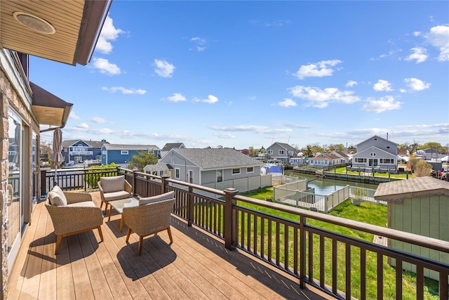 83 Central Ave, Amityville, NY 11701 - wooden deck featuring a residential view, a water view, a yard, and a fenced backyard