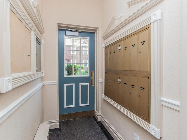 entryway with baseboards and mail area