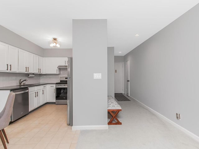 kitchen with stainless steel appliances, baseboards, decorative backsplash, and white cabinets