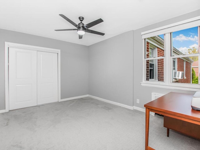 unfurnished office with baseboards, cooling unit, carpet flooring, and a ceiling fan