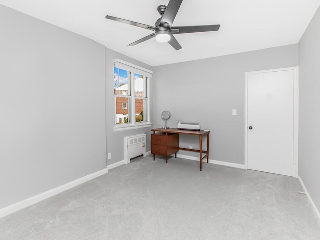 home office featuring carpet flooring, baseboards, a ceiling fan, and radiator heating unit