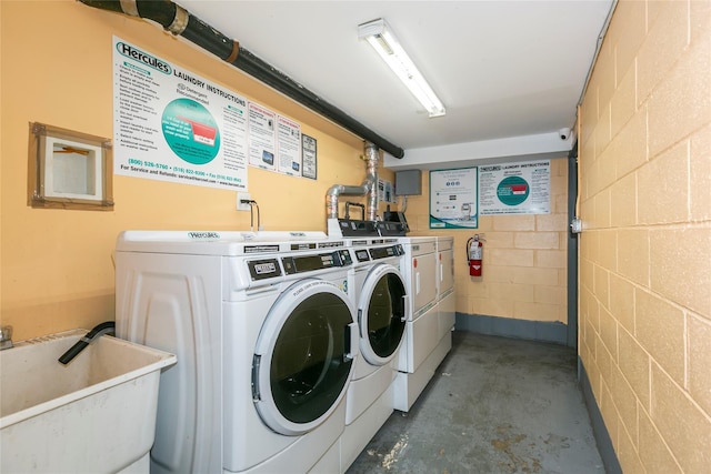 108-27 63rd Ave Unit 4B, Forest Hills, NY 11375 - shared laundry room featuring washing machine and clothes dryer and concrete block wall
