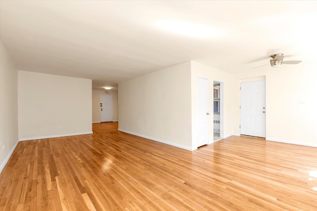unfurnished room featuring baseboards, a ceiling fan, and light wood-style flooring