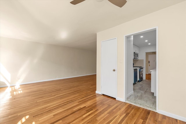 interior space with recessed lighting, ceiling fan, baseboards, and light wood-style floors