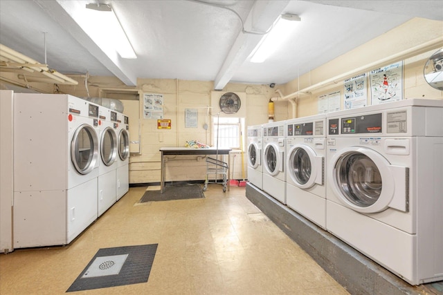 shared laundry area featuring light floors and independent washer and dryer