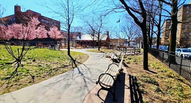 view of home's community featuring fence and a lawn