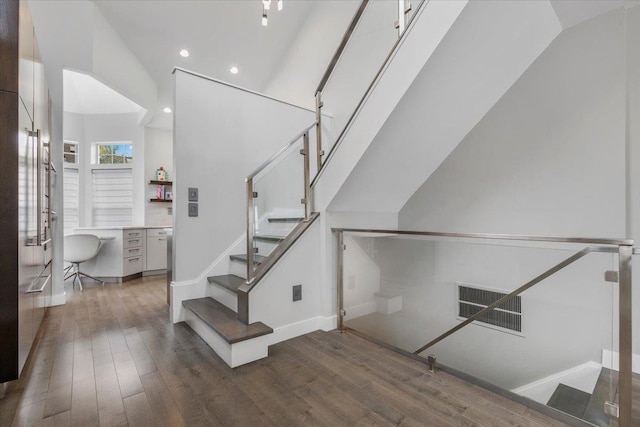 stairs with wood-type flooring, recessed lighting, baseboards, and visible vents