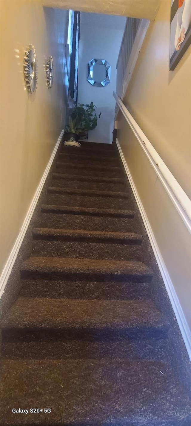 stairs featuring baseboards