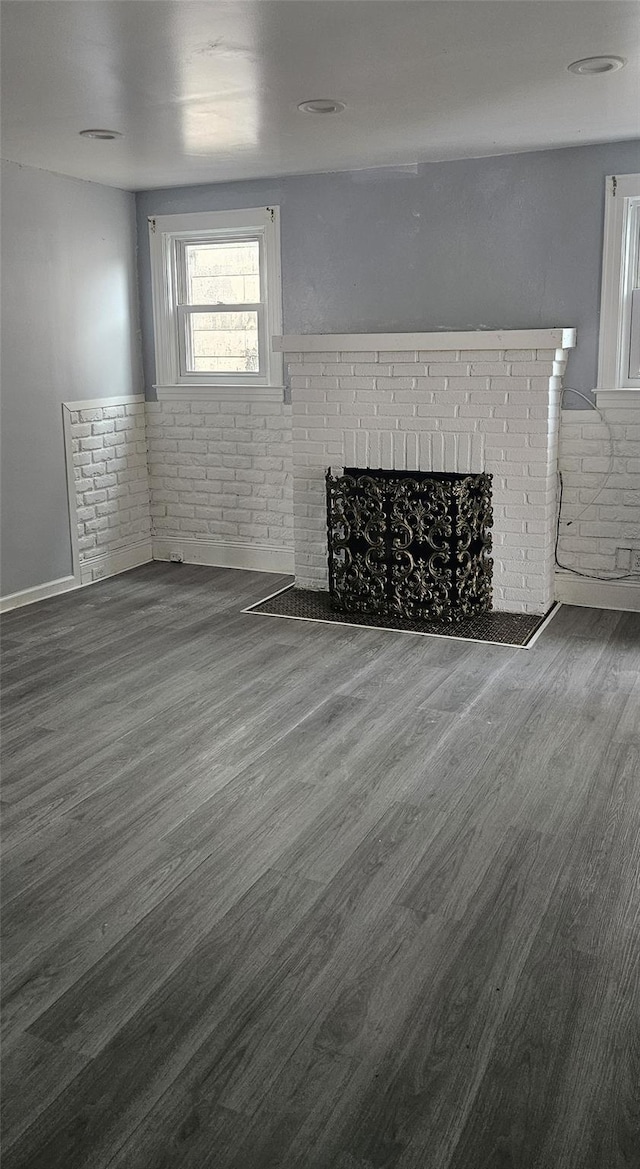 unfurnished living room with wood finished floors and a fireplace