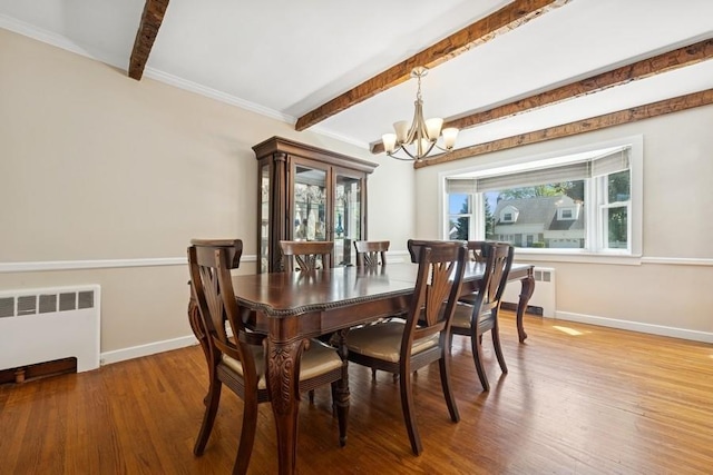 37 Remson St, Valley Stream, NY 11580 - dining space featuring radiator heating unit, a chandelier, beamed ceiling, plenty of natural light, and wood finished floors