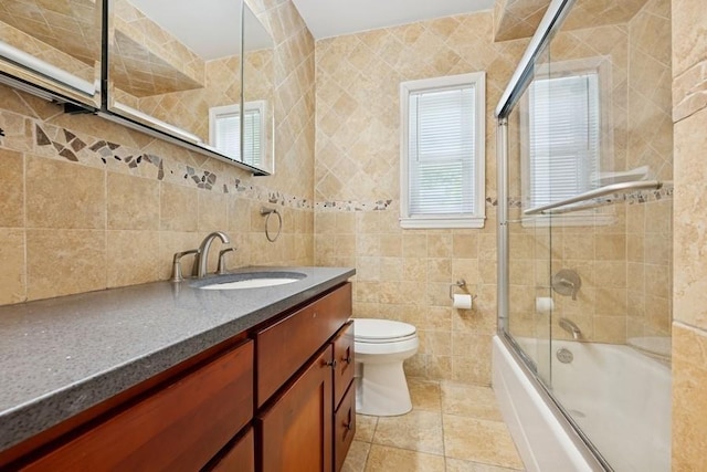 37 Remson St, Valley Stream, NY 11580 - bathroom with tile walls, plenty of natural light, vanity, toilet, and bath / shower combo with glass door