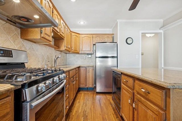 37 Remson St, Valley Stream, NY 11580 - kitchen featuring stainless steel appliances, under cabinet range hood, crown molding, light stone counters, and wood finished floors