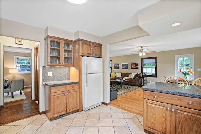 23 Hilldale Rd, Dobbs Ferry, NY 10522 - kitchen featuring freestanding refrigerator, glass insert cabinets, dark countertops, and light tile patterned flooring