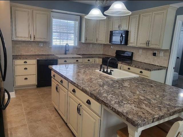 kitchen with a sink, tasteful backsplash, black appliances, and cream cabinetry