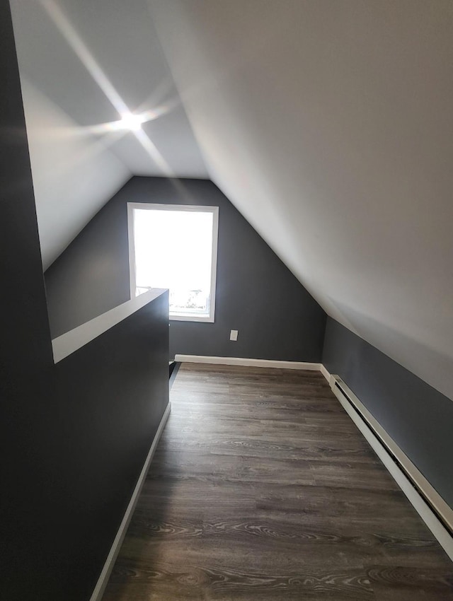 bonus room featuring baseboards, dark wood-style floors, baseboard heating, and lofted ceiling