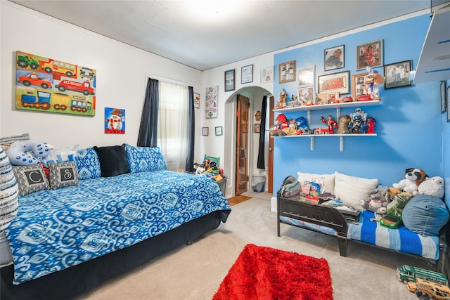 carpeted bedroom with arched walkways