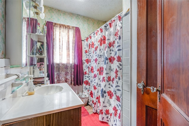 bathroom with vanity, wallpapered walls, a textured ceiling, and a shower with shower curtain