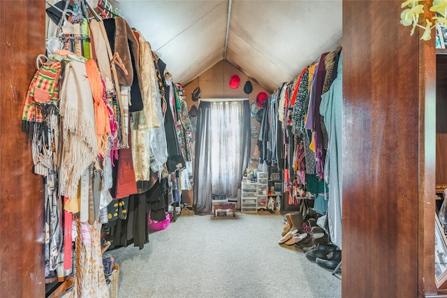 walk in closet with carpet and lofted ceiling