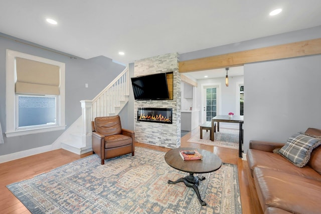92 Ridgewood Ave, Yonkers, NY 10704 - living area featuring stairs, recessed lighting, a stone fireplace, and wood finished floors