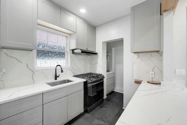 92 Ridgewood Ave, Yonkers, NY 10704 - kitchen featuring gas range, tasteful backsplash, light stone countertops, a sink, and under cabinet range hood