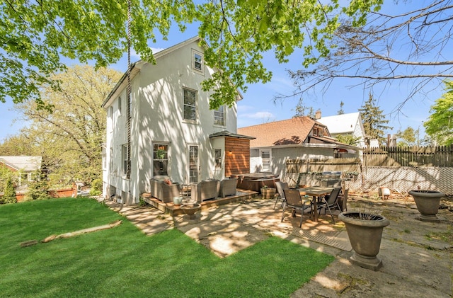 92 Ridgewood Ave, Yonkers, NY 10704 - rear view of house featuring fence, a hot tub, stucco siding, a patio area, and a yard