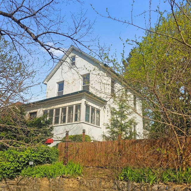 92 Ridgewood Ave, Yonkers, NY 10704 - view of home's exterior featuring fence and stucco siding